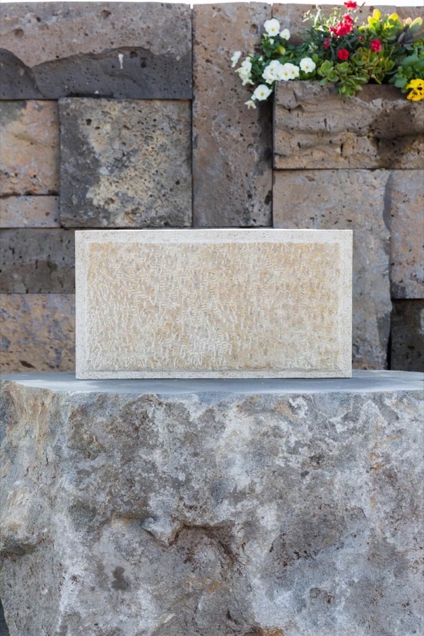 A finished stone headstone by Stone Living, set on a hand-cut plinth